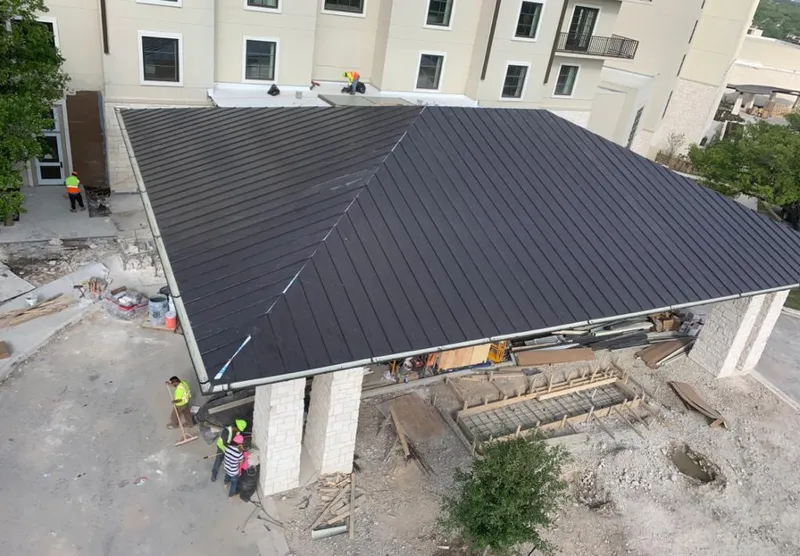 Metal roofing installation team working on a commercial building in Coventry